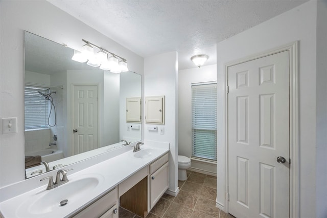 8526 Greenleaf Lake Dr, Houston, TX 77095 - full bathroom featuring double vanity,  shower combination, a textured ceiling, and tile patterned flooring