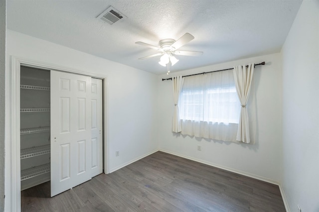 8526 Greenleaf Lake Dr, Houston, TX 77095 - unfurnished bedroom featuring wood finished floors, a closet, a ceiling fan, and a textured ceiling
