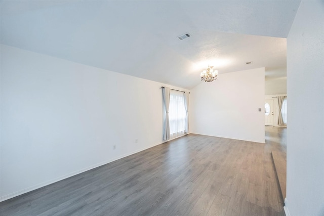 8526 Greenleaf Lake Dr, Houston, TX 77095 - spare room with a chandelier, vaulted ceiling, plenty of natural light, and wood finished floors