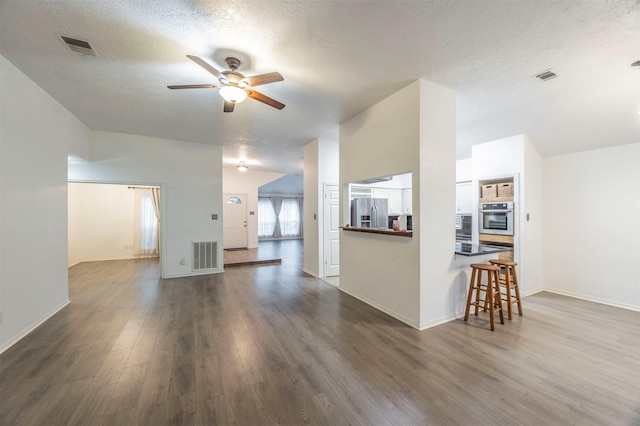 8526 Greenleaf Lake Dr, Houston, TX 77095 - living room featuring ceiling fan, dark wood-style floors, a textured ceiling, and lofted ceiling