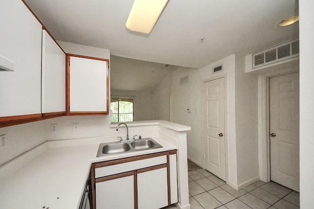3231 Allen Pkwy Unit 5303, Houston, TX 77019 - kitchen with light countertops, light tile patterned floors, white cabinets, and a peninsula