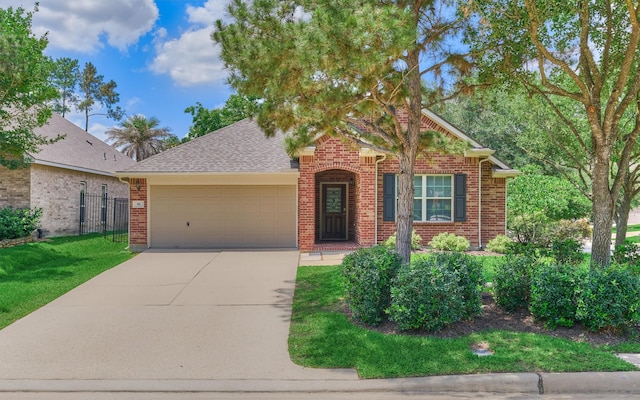 59 Pleasant Point Pl, Spring, TX 77389 - view of front of home featuring brick siding, an attached garage, concrete driveway, and roof with shingles