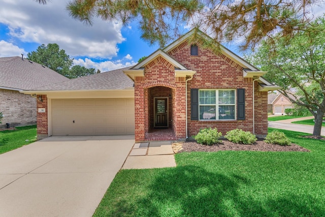 59 Pleasant Point Pl, Spring, TX 77389 - view of front of home featuring brick siding, a garage, concrete driveway, a front yard, and a shingled roof