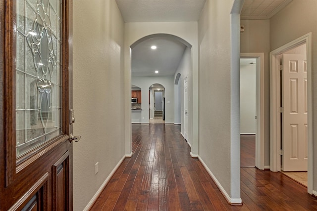 59 Pleasant Point Pl, Spring, TX 77389 - hallway with arched walkways, dark wood-type flooring, and a textured wall