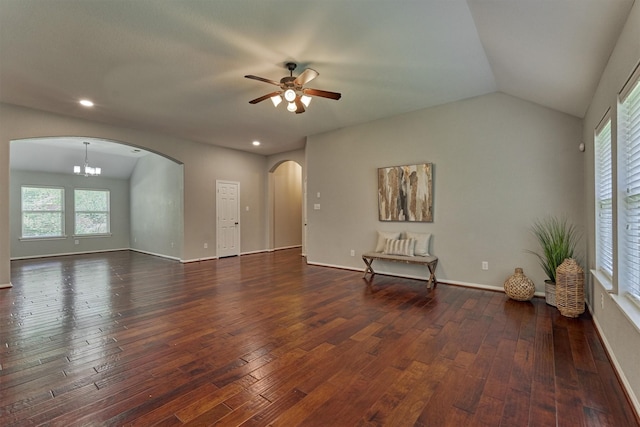 59 Pleasant Point Pl, Spring, TX 77389 - unfurnished living room featuring arched walkways, a ceiling fan, dark wood-style floors, plenty of natural light, and vaulted ceiling