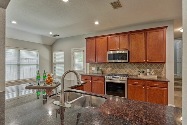 59 Pleasant Point Pl, Spring, TX 77389 - kitchen featuring stainless steel appliances, decorative backsplash, plenty of natural light, dark stone counters, and recessed lighting