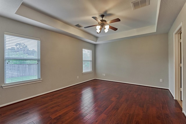 59 Pleasant Point Pl, Spring, TX 77389 - spare room featuring a raised ceiling, a ceiling fan, and dark wood-type flooring