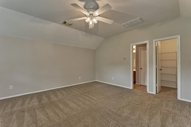 59 Pleasant Point Pl, Spring, TX 77389 - unfurnished bedroom with carpet flooring, vaulted ceiling, a walk in closet, and a ceiling fan