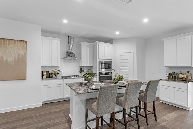 3913 Silver Fls, League City, TX 77573 - kitchen with appliances with stainless steel finishes, tasteful backsplash, a breakfast bar area, dark wood-type flooring, and recessed lighting