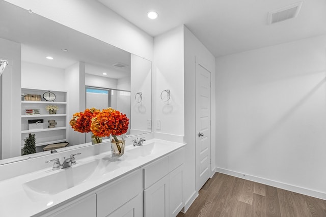 3913 Silver Fls, League City, TX 77573 - bathroom with wood finished floors, double vanity, a shower with shower door, a closet, and recessed lighting