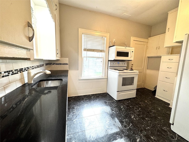 2616 Beauchamp St, Houston, TX 77009 - kitchen with white appliances, decorative backsplash, and white cabinetry