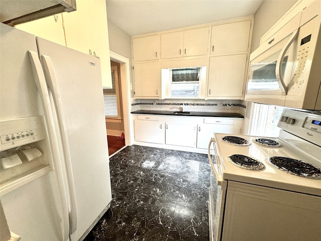 2616 Beauchamp St, Houston, TX 77009 - kitchen with white appliances, decorative backsplash, and dark countertops