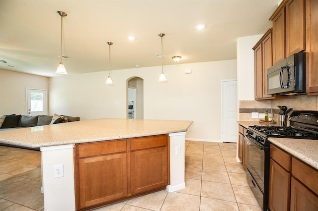 511 Moore St, Richwood, TX 77531 - kitchen with black appliances, arched walkways, decorative backsplash, light tile patterned flooring, and a kitchen island