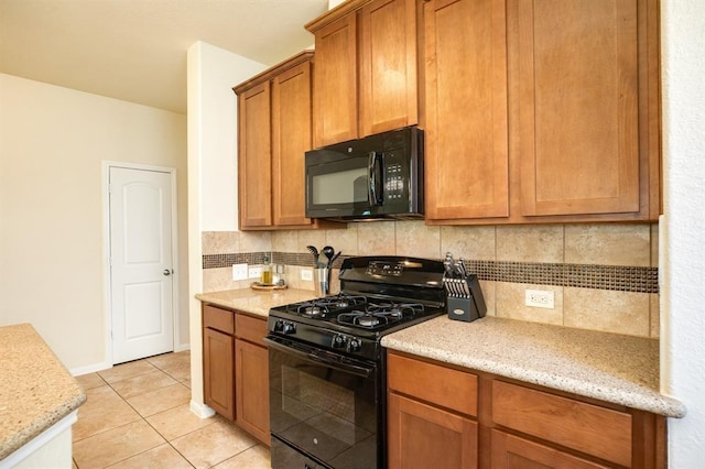 511 Moore St, Richwood, TX 77531 - kitchen with black appliances, backsplash, light tile patterned floors, and light stone countertops