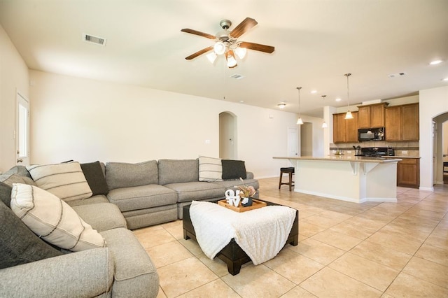 511 Moore St, Richwood, TX 77531 - living area with arched walkways, a ceiling fan, light tile patterned flooring, and recessed lighting