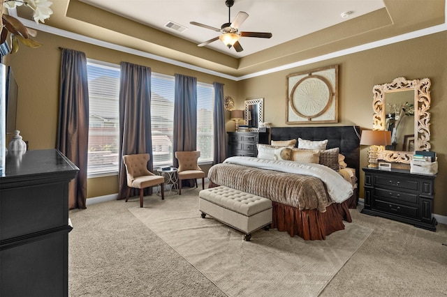 1509 Preserve Ln, Pearland, TX 77089 - carpeted bedroom with a tray ceiling, multiple windows, and ceiling fan