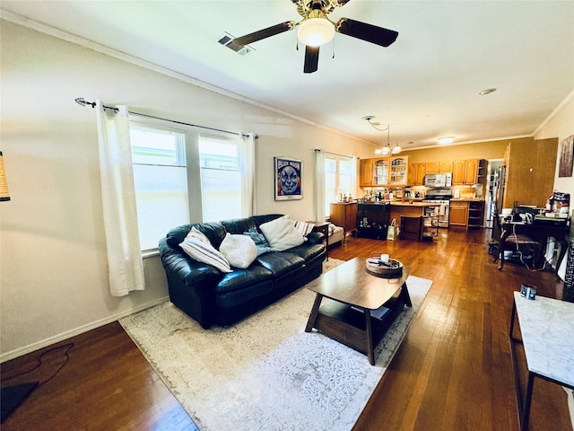 2614 Beauchamp St, Houston, TX 77009 - living area with ornamental molding, dark wood-style flooring, a ceiling fan, and a chandelier