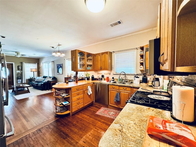 2614 Beauchamp St, Houston, TX 77009 - kitchen featuring appliances with stainless steel finishes, dark wood-style floors, open shelves, brown cabinets, and plenty of natural light