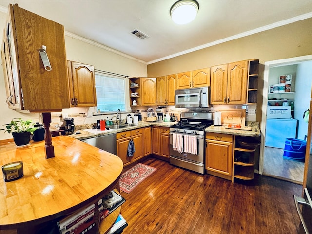 2614 Beauchamp St, Houston, TX 77009 - kitchen with appliances with stainless steel finishes, open shelves, ornamental molding, dark wood finished floors, and brown cabinetry