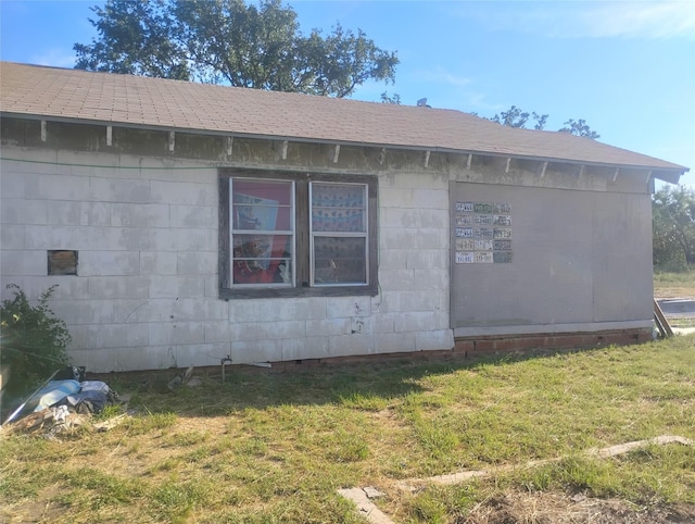 7510 US Highway 67 Unit 84, Bangs, TX 76823 - view of side of property featuring concrete block siding and a yard