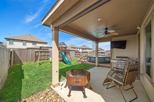 22526 Belmont Cove Ln, Katy, TX 77449 - fenced backyard featuring a playground, a patio, ceiling fan, area for grilling, and a residential view