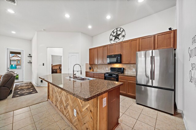 22526 Belmont Cove Ln, Katy, TX 77449 - kitchen with black appliances, light tile patterned floors, brown cabinets, light carpet, and backsplash