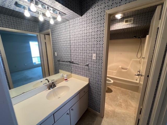 7655 S Braeswood Blvd Unit 8, Houston, TX 77071 - bathroom with wallpapered walls, vanity, shower / bath combination, and tile patterned flooring