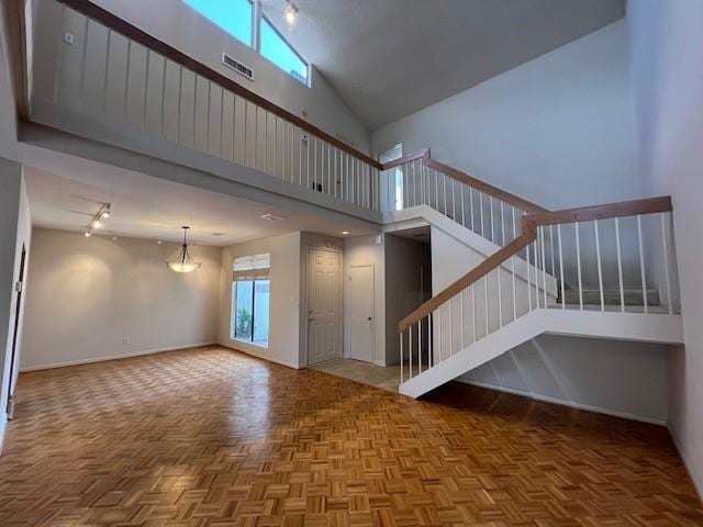7655 S Braeswood Blvd Unit 8, Houston, TX 77071 - unfurnished living room featuring stairway and a high ceiling