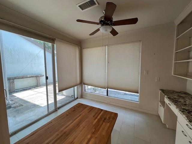 7655 S Braeswood Blvd Unit 8, Houston, TX 77071 - unfurnished dining area featuring ceiling fan and crown molding
