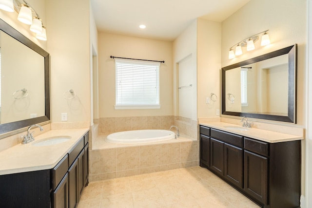 10306 Terra St, Iowa Colony, TX 77583 - bathroom featuring two vanities, a bath, and tile patterned flooring