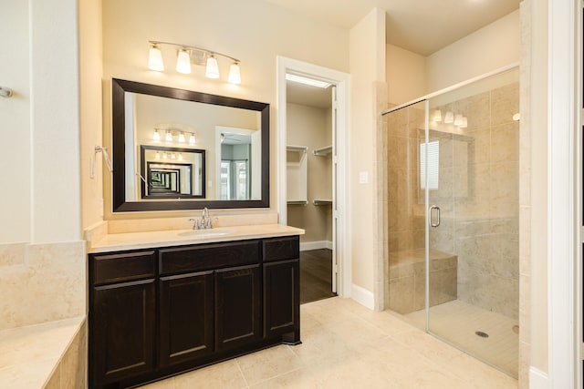 10306 Terra St, Iowa Colony, TX 77583 - full bathroom featuring a stall shower, vanity, tile patterned flooring, and a spacious closet