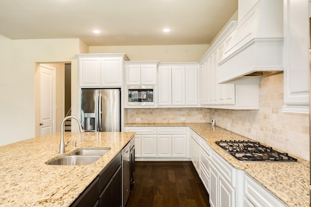 10306 Terra St, Iowa Colony, TX 77583 - kitchen featuring stainless steel appliances, dark wood finished floors, premium range hood, white cabinetry, and recessed lighting