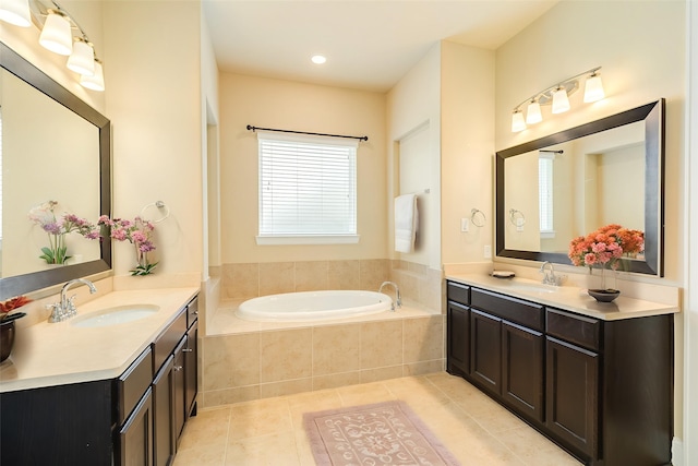 10306 Terra St, Iowa Colony, TX 77583 - bathroom featuring two vanities, a garden tub, and tile patterned flooring
