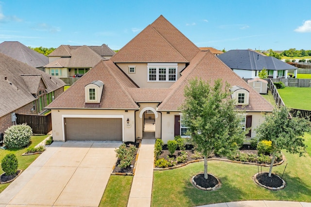 10306 Terra St, Iowa Colony, TX 77583 - french provincial home with stucco siding, driveway, a garage, a residential view, and roof with shingles