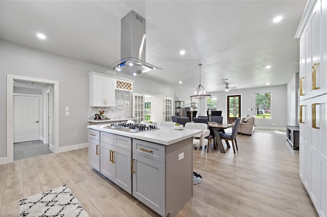 459 Live Oak Rd, Wharton, TX 77488 - kitchen featuring island exhaust hood, stainless steel gas cooktop, a center island, open floor plan, and recessed lighting
