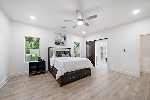459 Live Oak Rd, Wharton, TX 77488 - bedroom with a barn door, multiple windows, light wood finished floors, and recessed lighting