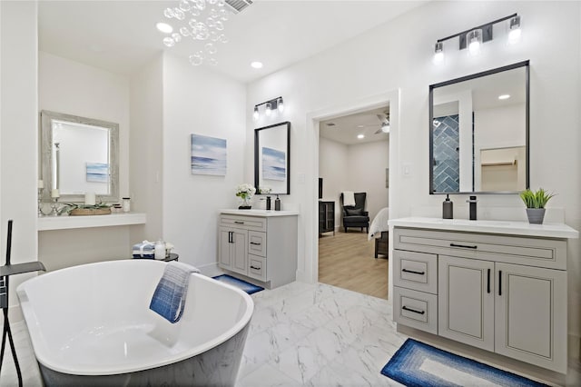 459 Live Oak Rd, Wharton, TX 77488 - ensuite bathroom featuring two vanities, a soaking tub, a ceiling fan, recessed lighting, and marble finish floors