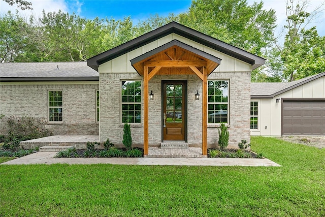 459 Live Oak Rd, Wharton, TX 77488 - property entrance with a lawn, board and batten siding, a garage, and roof with shingles