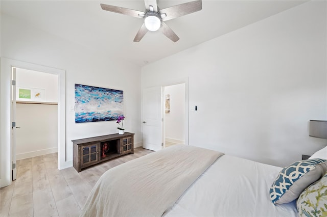459 Live Oak Rd, Wharton, TX 77488 - bedroom featuring light wood-type flooring, a ceiling fan, and a spacious closet