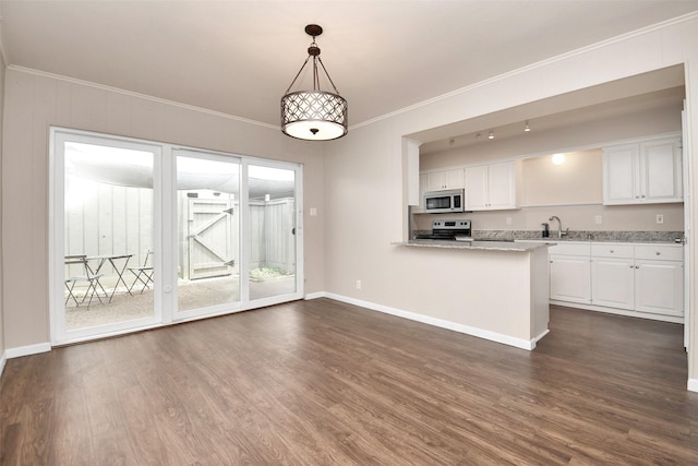 6307 Briar Rose Dr Unit 120, Houston, TX 77057 - kitchen with stainless steel microwave, electric range, white cabinets, dark wood finished floors, and crown molding
