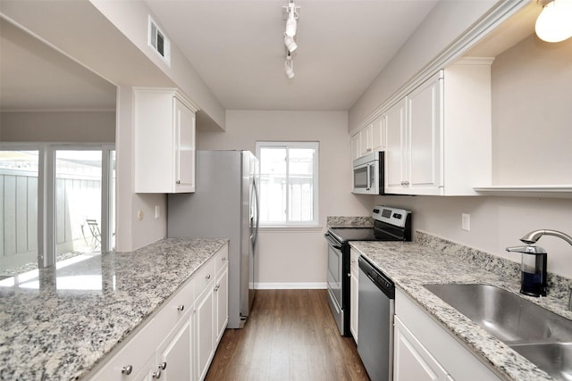 6307 Briar Rose Dr Unit 120, Houston, TX 77057 - kitchen featuring stainless steel appliances, white cabinetry, dark wood-style flooring, and light stone countertops