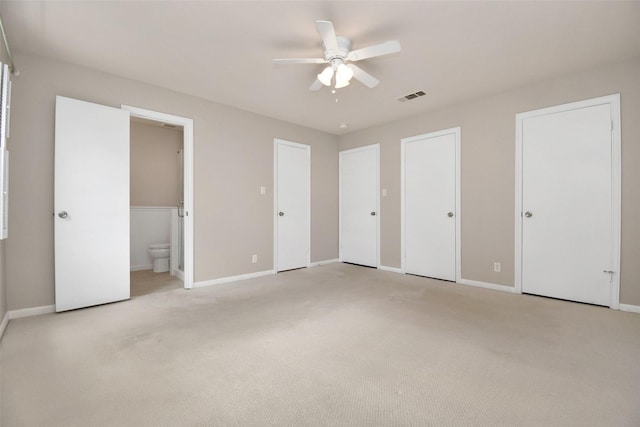 6307 Briar Rose Dr Unit 120, Houston, TX 77057 - unfurnished bedroom with multiple closets, light carpet, connected bathroom, and a ceiling fan