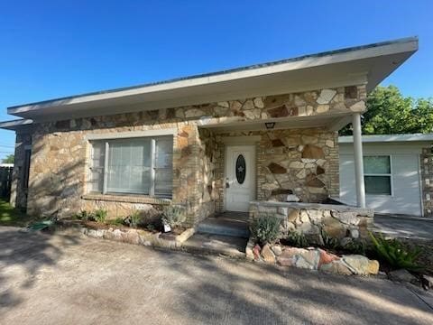 1114 E Pecan St, Angleton, TX 77515 - view of front of home featuring stone siding