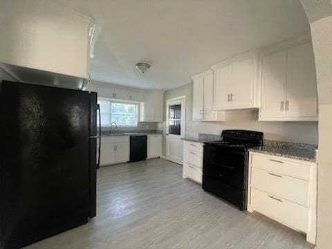 1114 E Pecan St, Angleton, TX 77515 - kitchen with black appliances, light wood-style floors, white cabinets, and light stone countertops