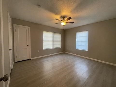 1114 E Pecan St, Angleton, TX 77515 - spare room featuring wood finished floors, ceiling fan, and a textured ceiling