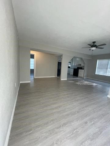 1114 E Pecan St, Angleton, TX 77515 - unfurnished living room with a ceiling fan and wood finished floors