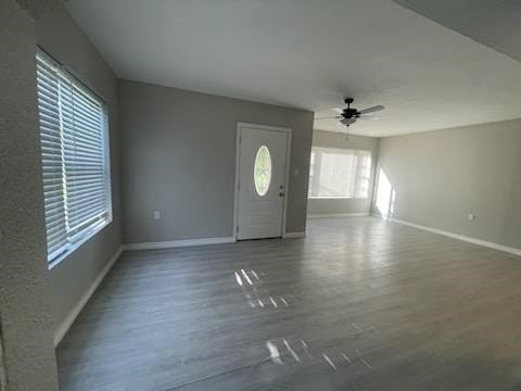 1114 E Pecan St, Angleton, TX 77515 - unfurnished living room featuring a ceiling fan and wood finished floors