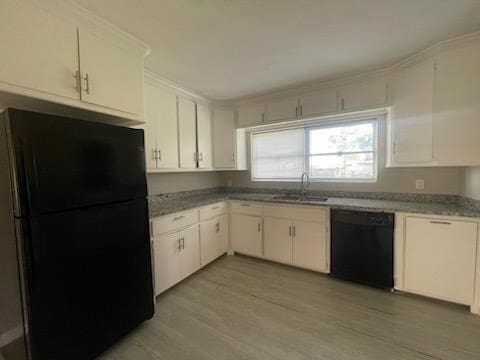 1114 E Pecan St, Angleton, TX 77515 - kitchen with black appliances, light wood-style flooring, and white cabinetry