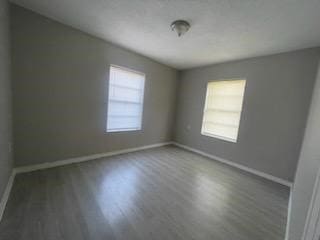 1114 E Pecan St, Angleton, TX 77515 - spare room with wood finished floors and baseboards