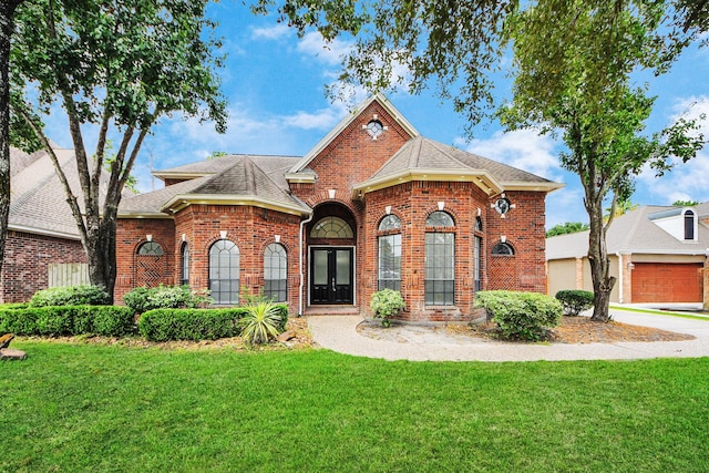16015 Conners Ace Dr, Spring, TX 77379 - view of front of house with brick siding, a front lawn, roof with shingles, and a garage